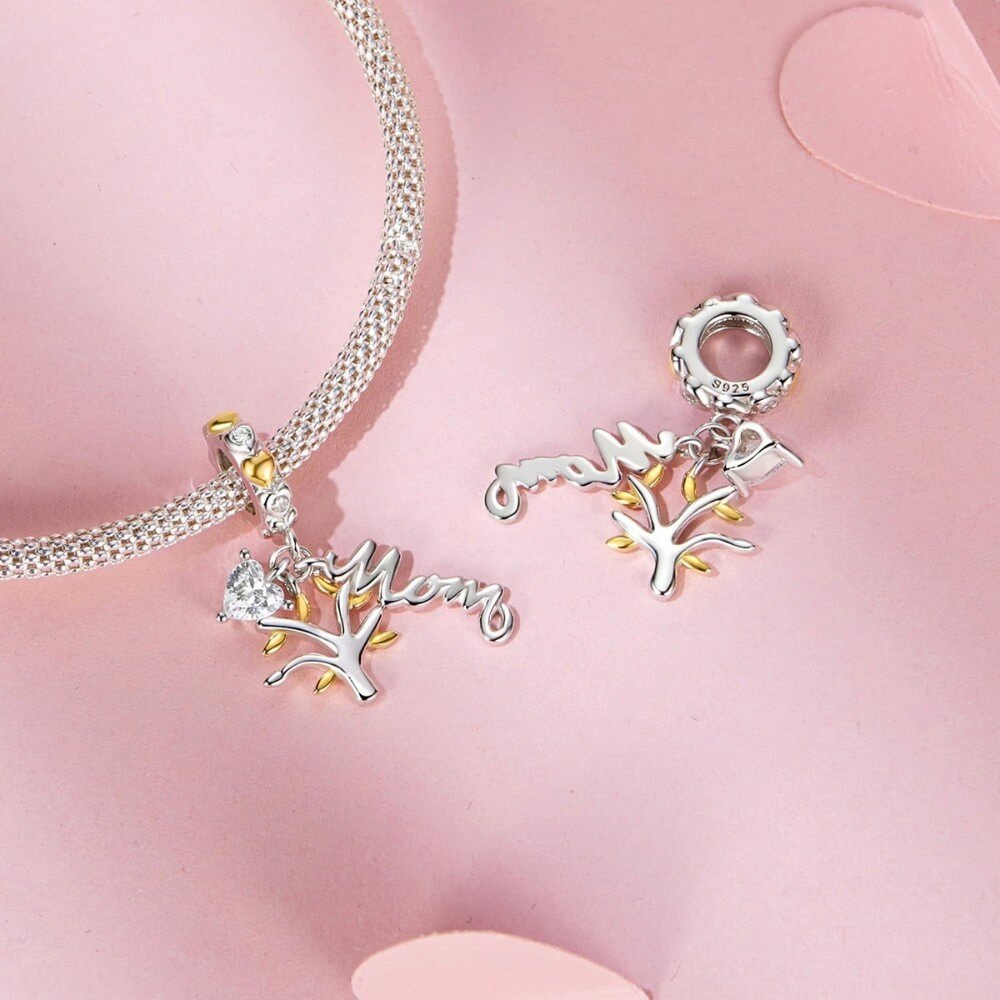 Sterling silver family tree charm with mom script and heart crystal.