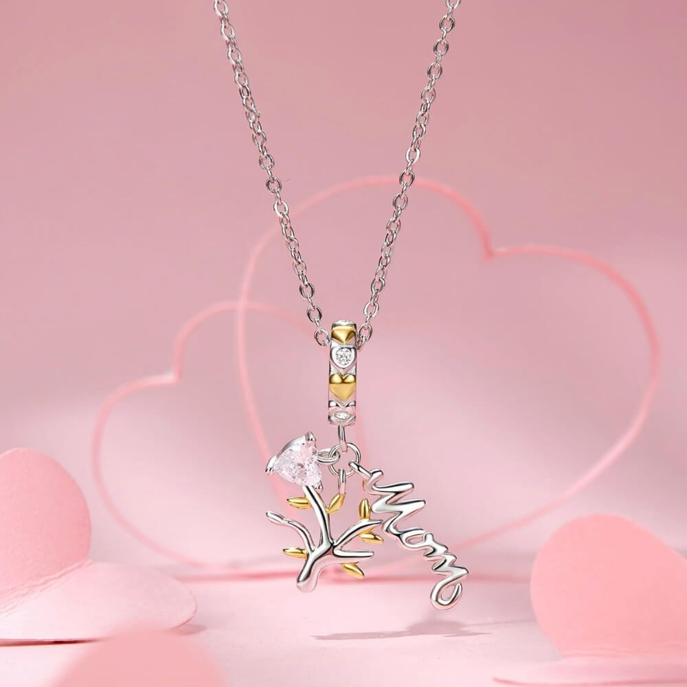 Sterling silver family tree charm with mom script and heart crystal.