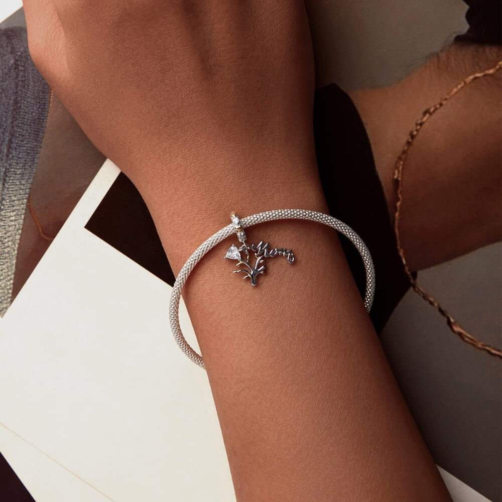 Sterling silver family tree charm with mom script and heart crystal.
