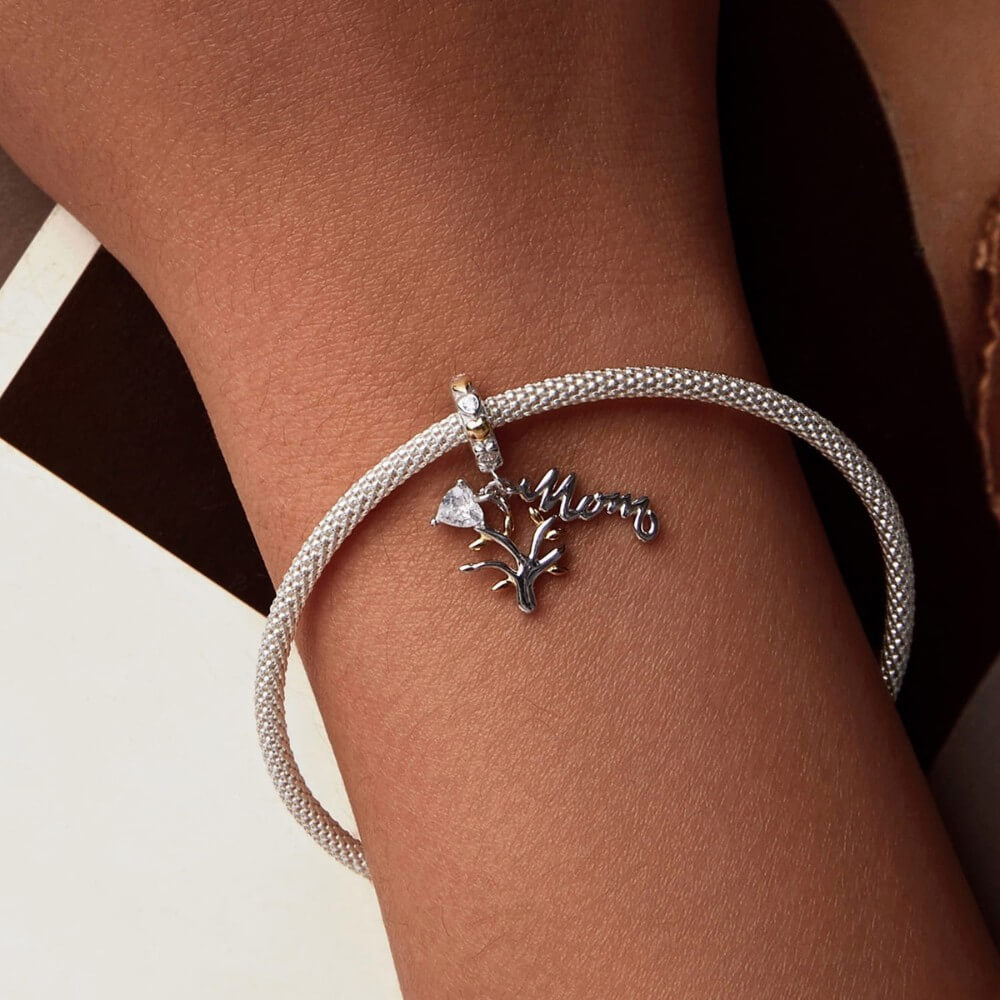Sterling silver family tree charm with mom script and heart crystal.