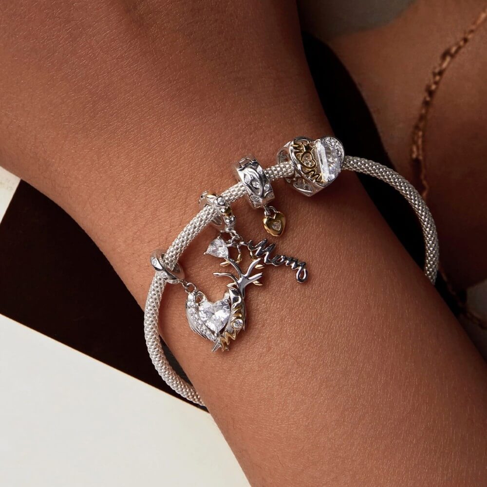 Sterling silver family tree charm with mom script and heart crystal.
