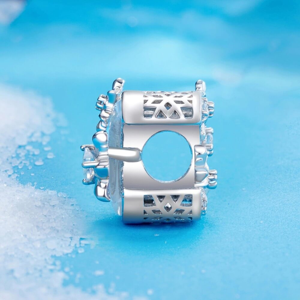 Sterling silver moon charm with iridescent enamel and floral crystal details.