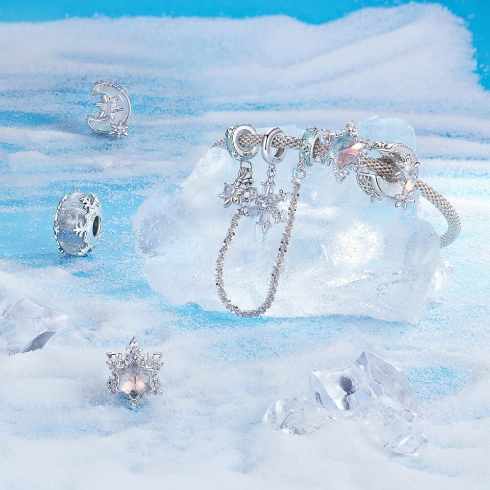 Sterling silver moon charm with iridescent enamel and floral crystal details.