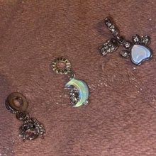 Sterling silver unicorn charm on moon with opalescent glow.