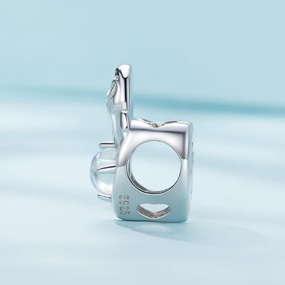 Sterling silver mother and baby charm with iridescent heart detail.