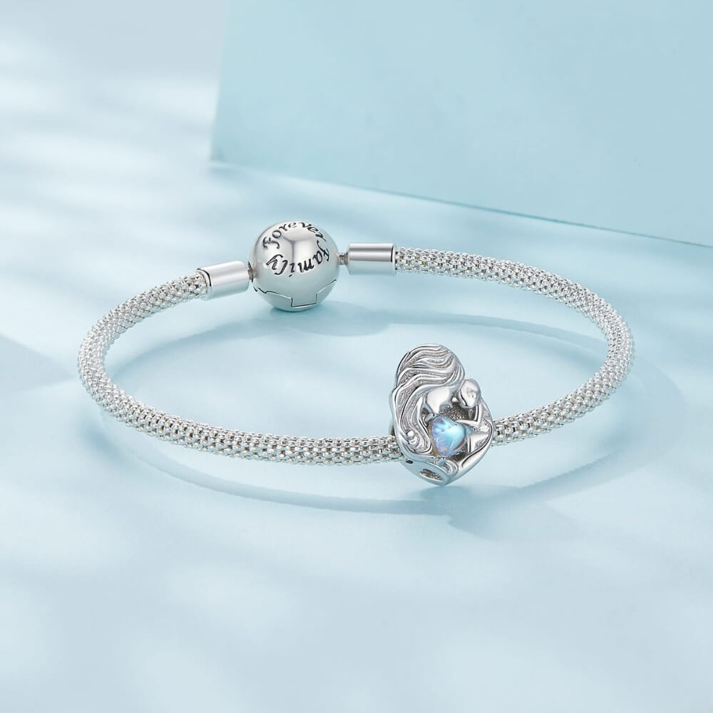 Sterling silver mother and baby charm with iridescent heart detail.