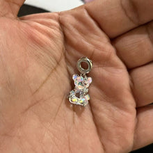 Sterling silver teddy bear charm with pink opalescent glass and crystal accents.