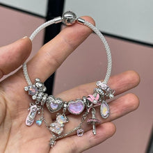 Sterling silver teddy bear charm with pink opalescent glass and crystal accents.
