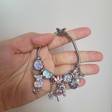 Sterling silver teddy bear charm with pink opalescent glass and crystal accents.