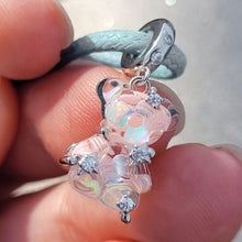 Sterling silver teddy bear charm with pink opalescent glass and crystal accents.