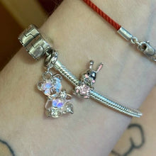 Sterling silver teddy bear charm with pink opalescent glass and crystal accents.