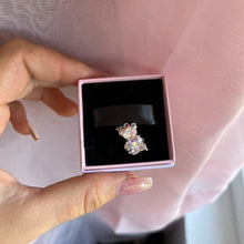Sterling silver teddy bear charm with pink opalescent glass and crystal accents.