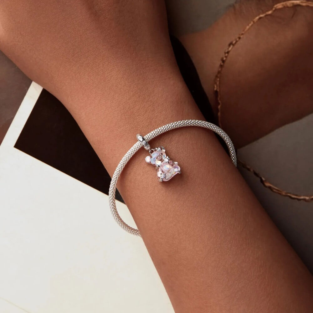 Sterling silver teddy bear charm with pink opalescent glass and crystal accents.