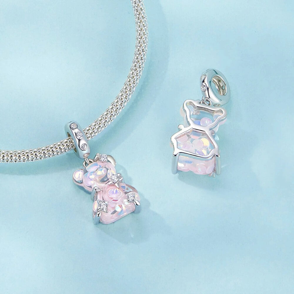 Sterling silver teddy bear charm with pink opalescent glass and crystal accents.
