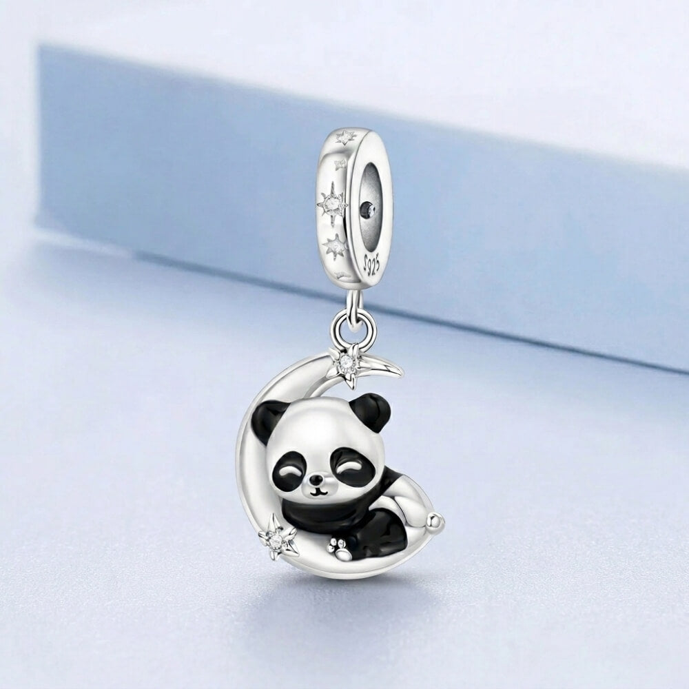 Sterling silver panda charm resting on crescent moon with star details.