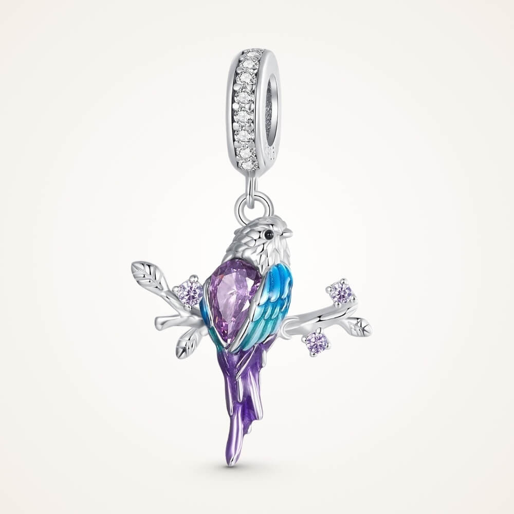 Sterling silver parrot charm with purple crystal, blue enamel, and branch details - ORÉYA
