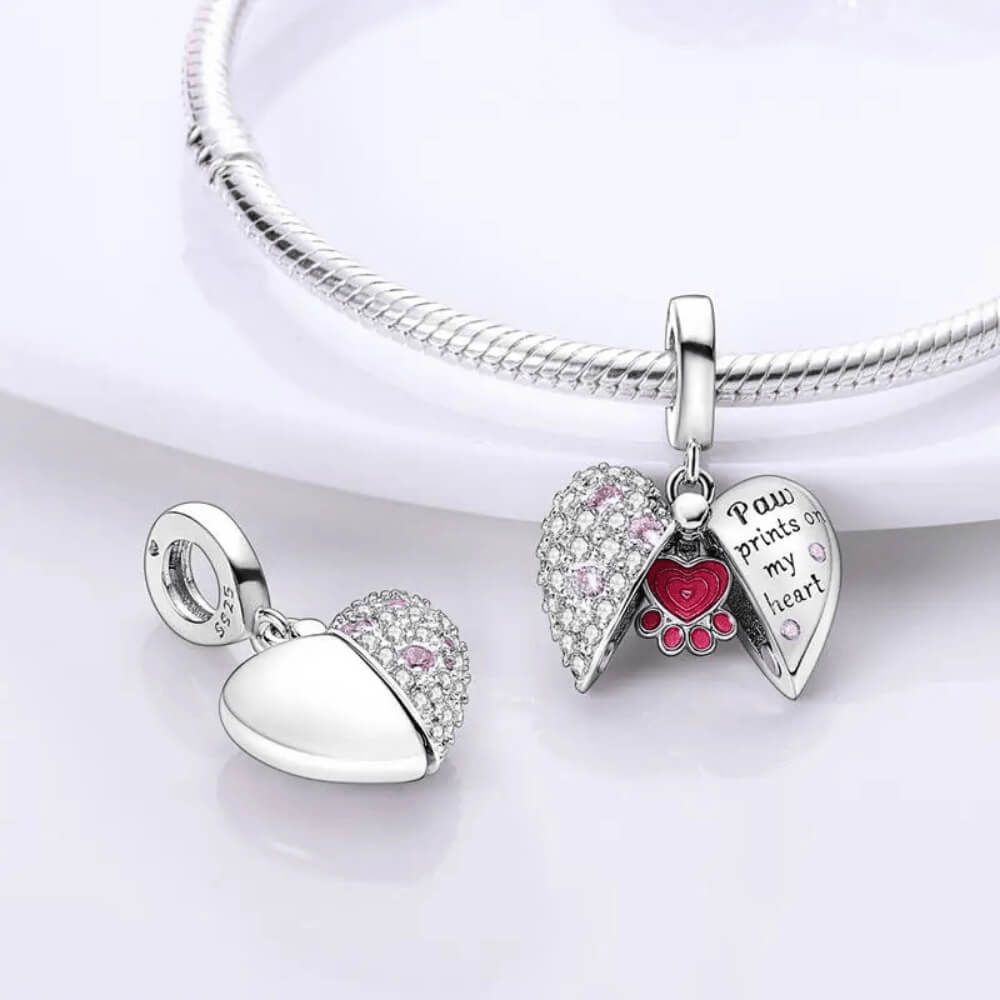 Sterling silver locket-style charm with pink paw heart detail and ‘Paw prints on my heart’ engraving