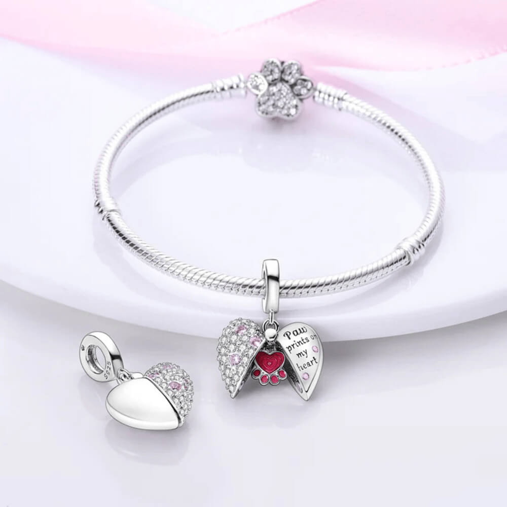 Sterling silver locket-style charm with pink paw heart detail and ‘Paw prints on my heart’ engraving 