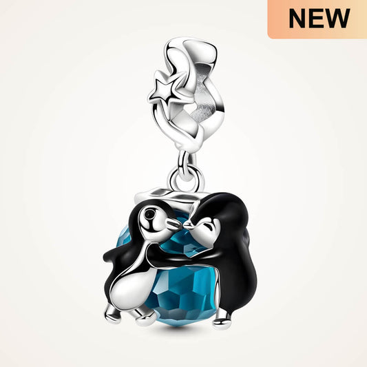 Sterling silver penguin couple charm with blue faceted crystal and star-detailed bail - ORÉYA