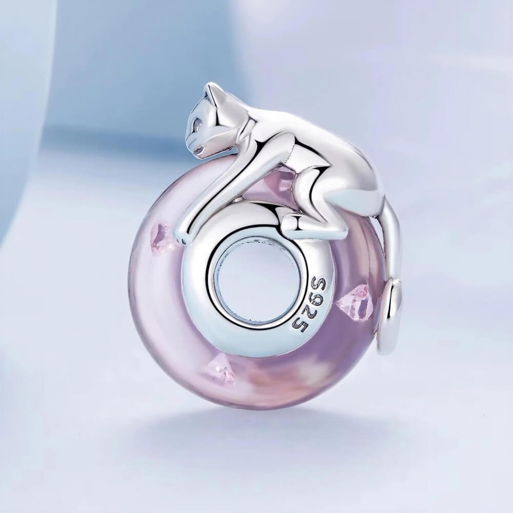 Sterling silver cat charm with pink crystal body and heart detail.