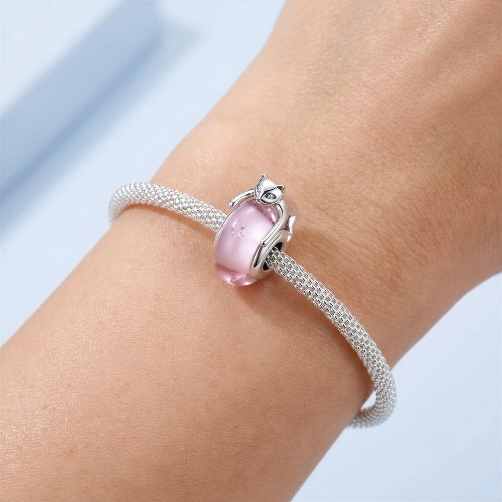 Sterling silver cat charm with pink crystal body and heart detail.
