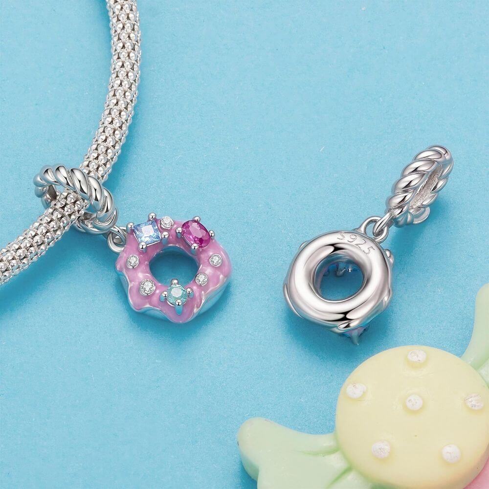 Sterling silver donut charm with pink frosting, colorful crystal sprinkles, and a twisted silver bail.