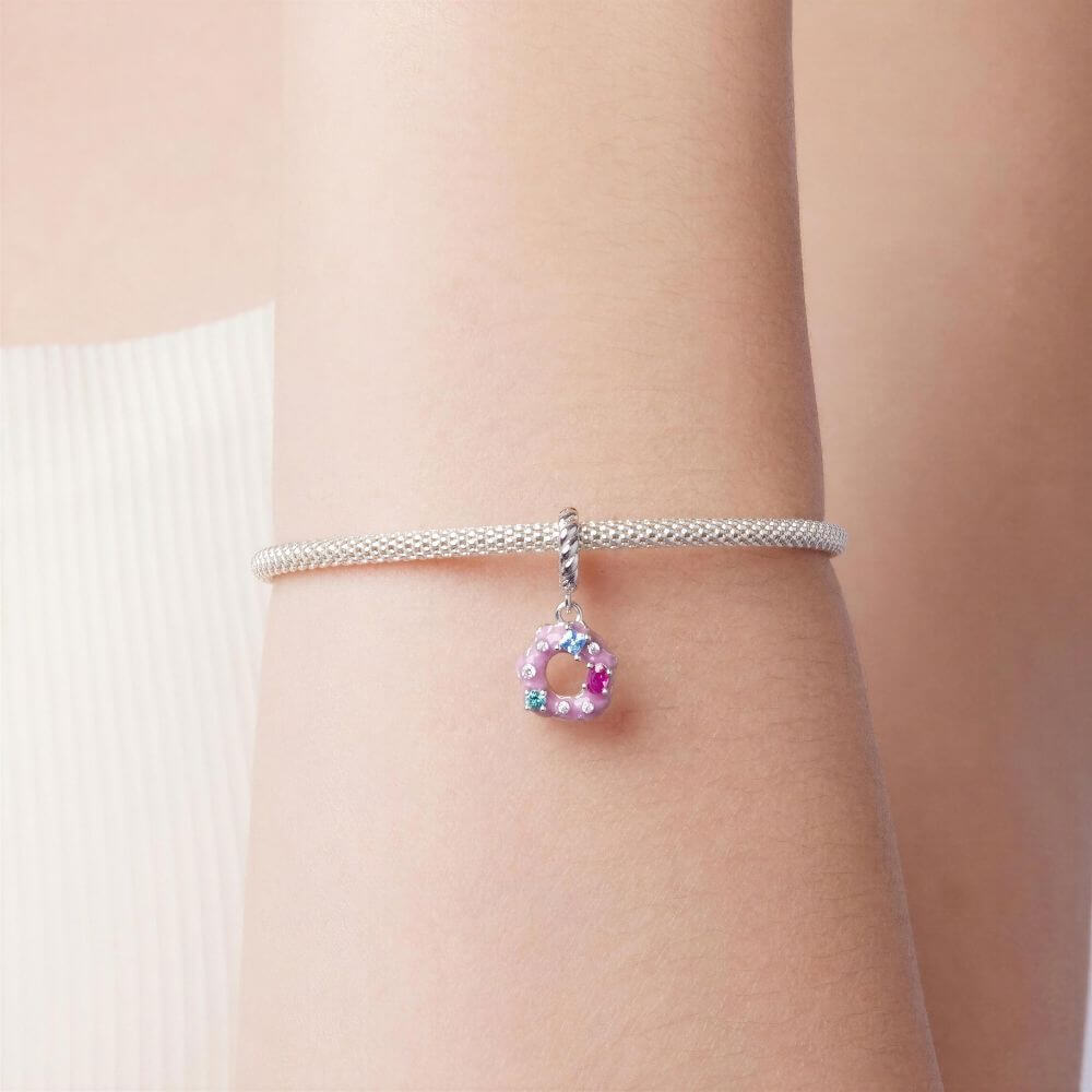 Sterling silver donut charm with pink frosting, colorful crystal sprinkles, and a twisted silver bail.