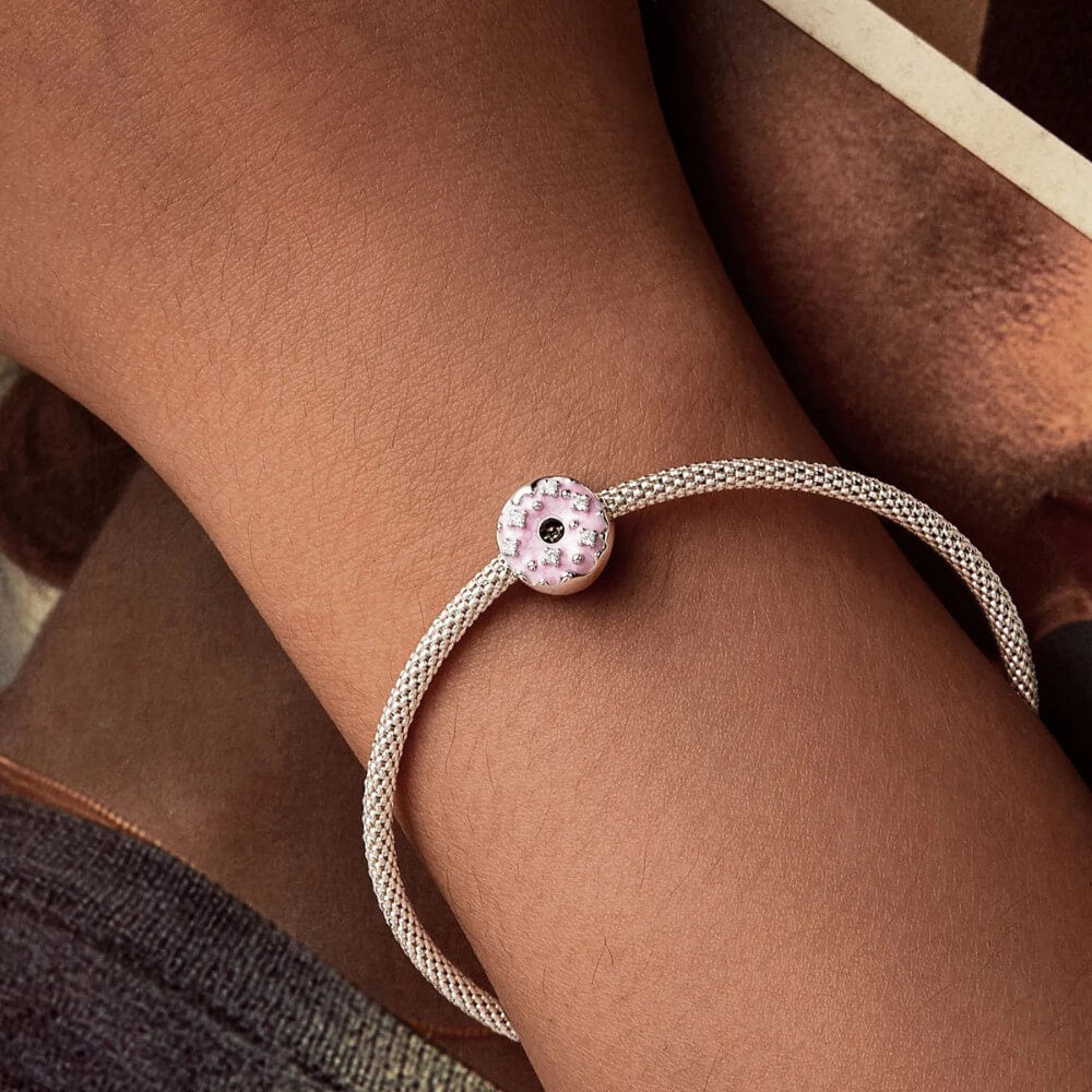 Sterling silver donut charm with pink enamel and crystal accents.