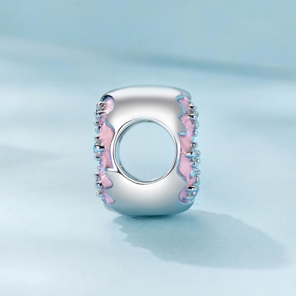 Sterling silver donut charm with pink enamel and crystal accents.