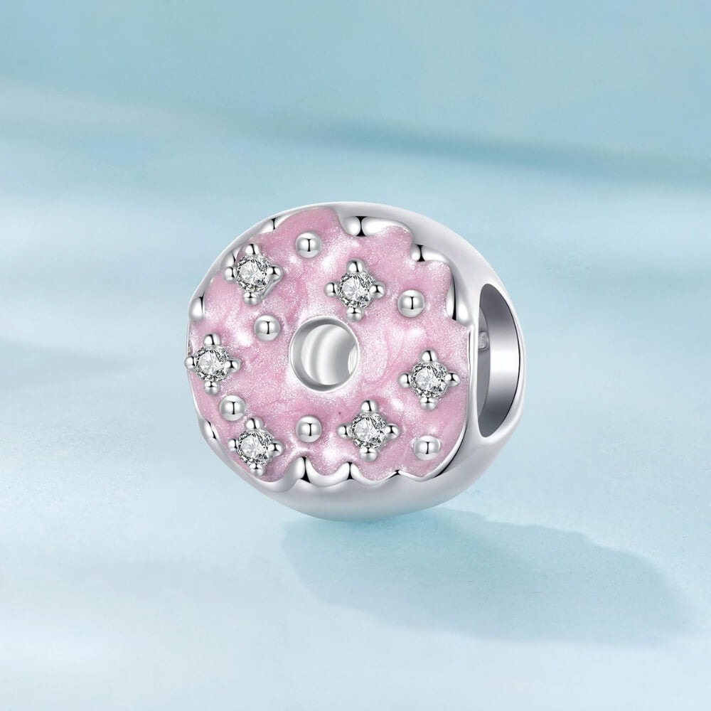 Sterling silver donut charm with pink enamel and crystal accents.