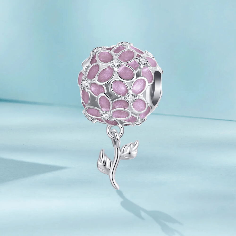 Sterling silver charm with pink enamel flowers, crystal flower centers, and a dangling silver leaf stem 