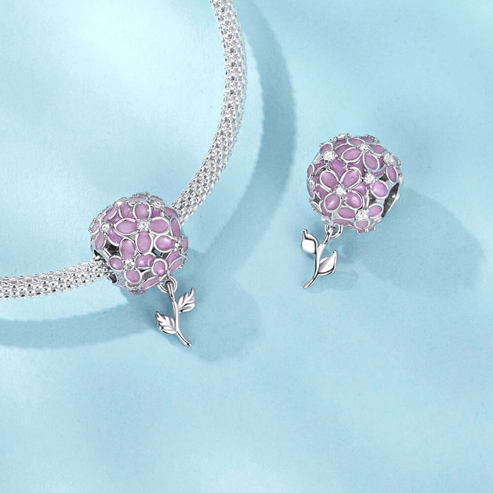 Sterling silver charm with pink enamel flowers, crystal flower centers, and a dangling silver leaf stem