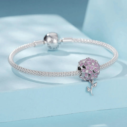 Sterling silver charm with pink enamel flowers, crystal flower centers, and a dangling silver leaf stem