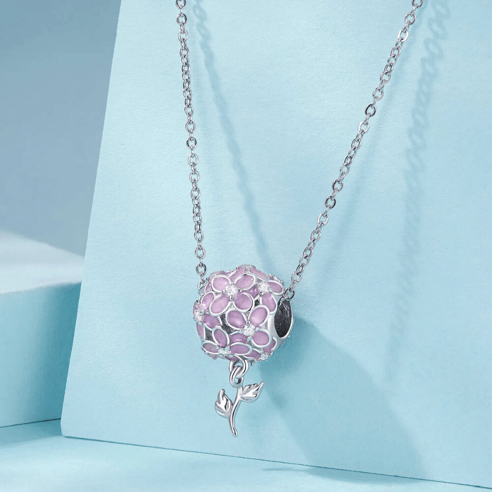 Sterling silver charm with pink enamel flowers, crystal flower centers, and a dangling silver leaf stem 