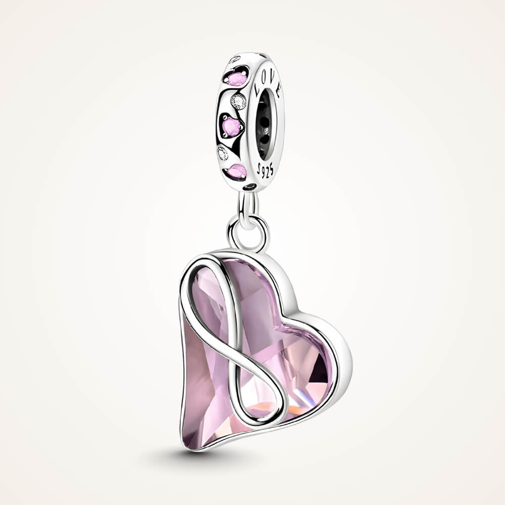 Sterling silver dangle charm with a faceted light-pink crystal heart wrapped in an infinity symbol and pink heart stones on the bail – ORÉYA.