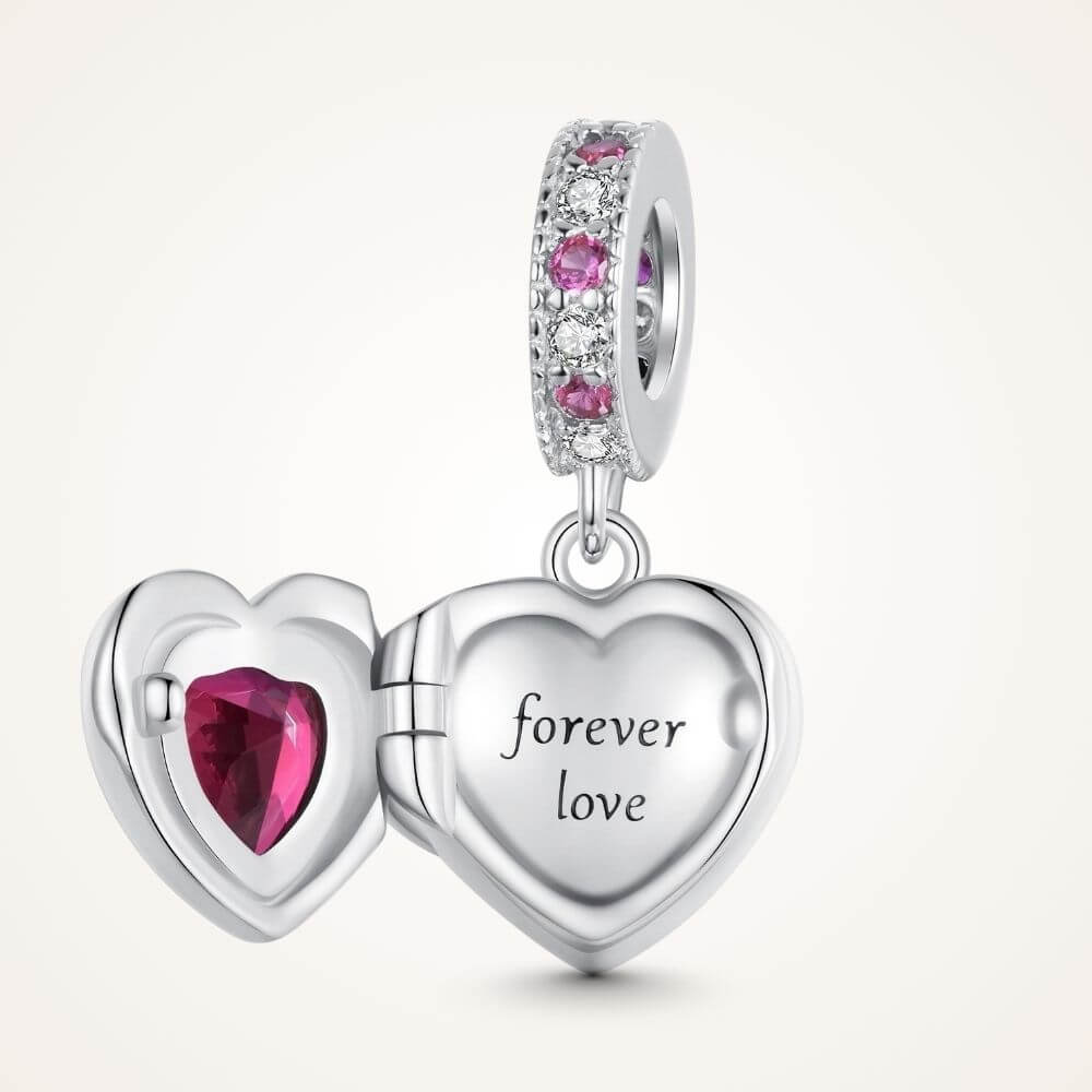 Sterling silver heart locket charm with deep pink crystal center and sparkling pink and clear stone details - ORÉYA