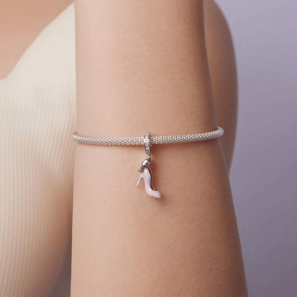 Sterling silver high heel charm with pink enamel and bow detail.