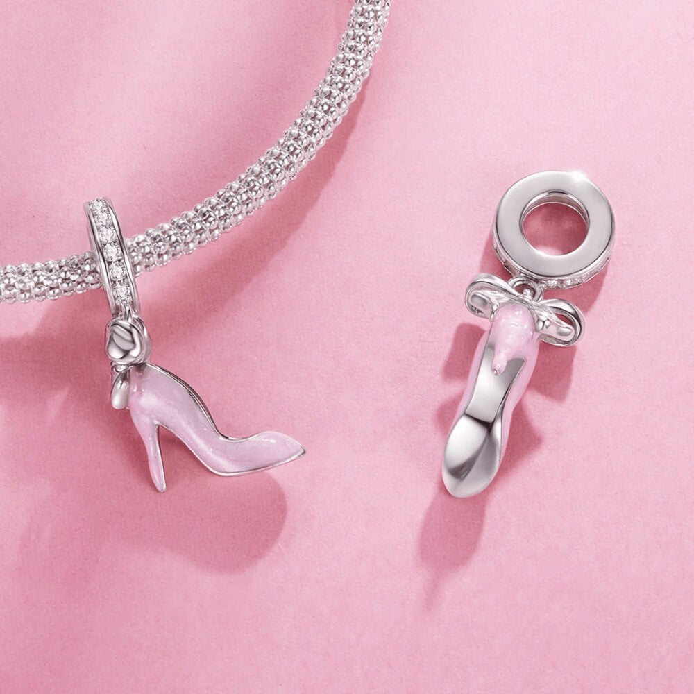 Sterling silver high heel charm with pink enamel and bow detail.
