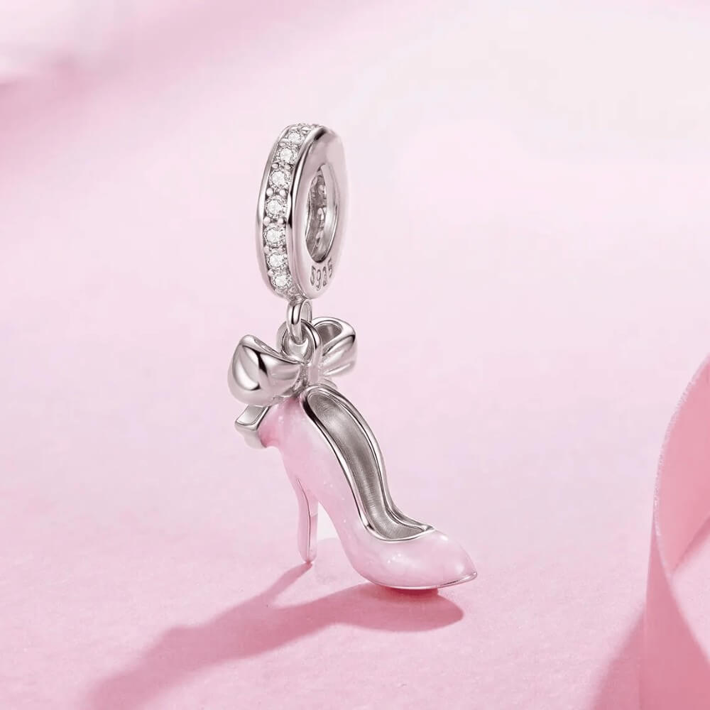 Sterling silver high heel charm with pink enamel and bow detail.