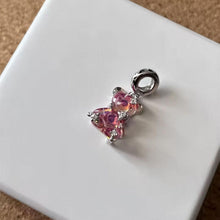 Sterling silver pink teddy bear charm with iridescent finish, sparkling stars, and clear crystal accents.