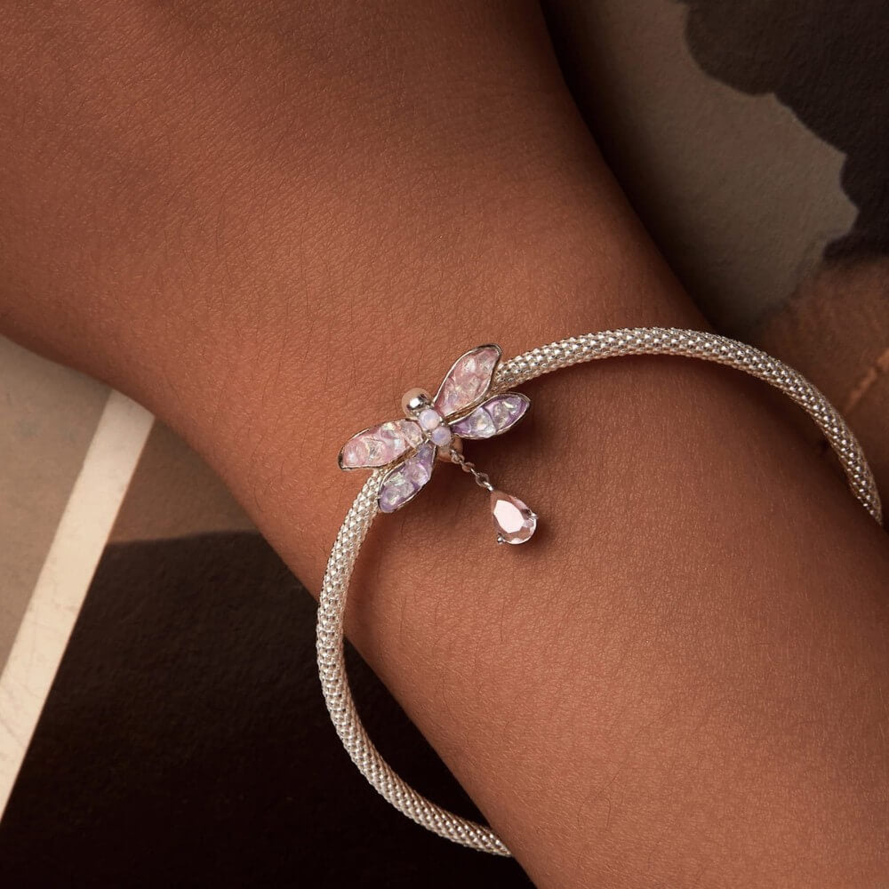 Bracelet with a dragonfly design on a wrist