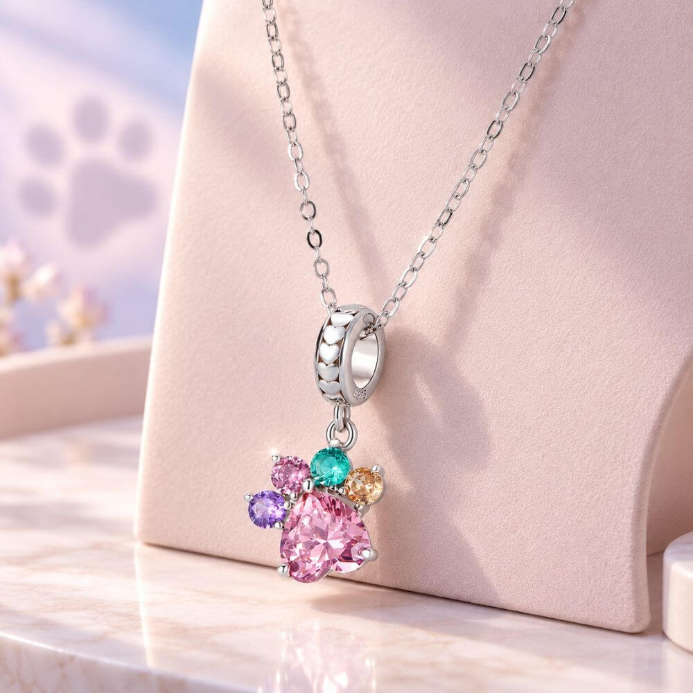 Sterling silver paw print charm with large pink heart crystal and colorful gemstone toe details.