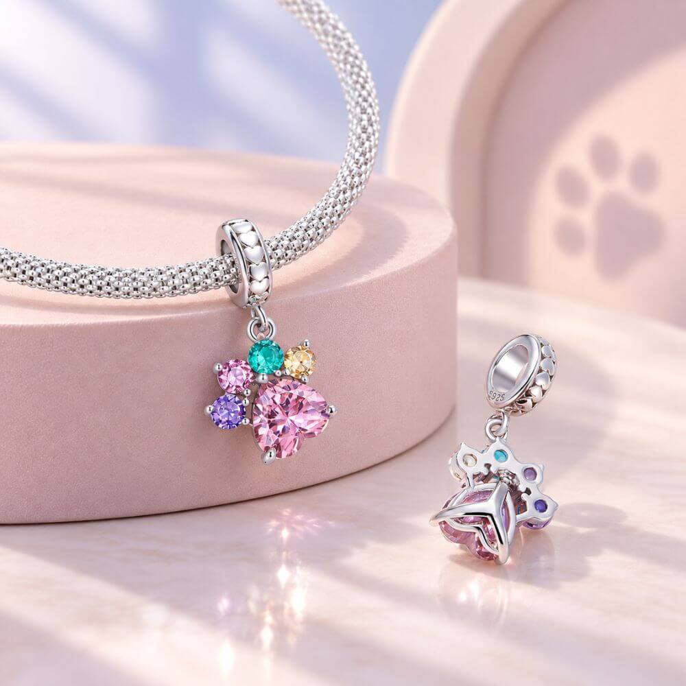 Sterling silver paw print charm with large pink heart crystal and colorful gemstone toe details.