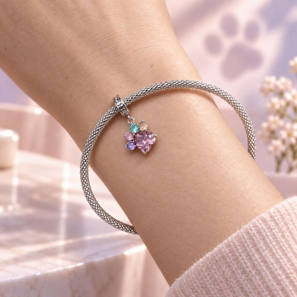 Sterling silver paw print charm with large pink heart crystal and colorful gemstone toe details.