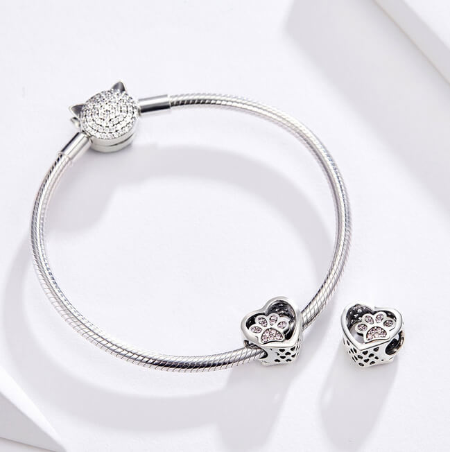 Sterling silver heart charm with pink crystal paw print center