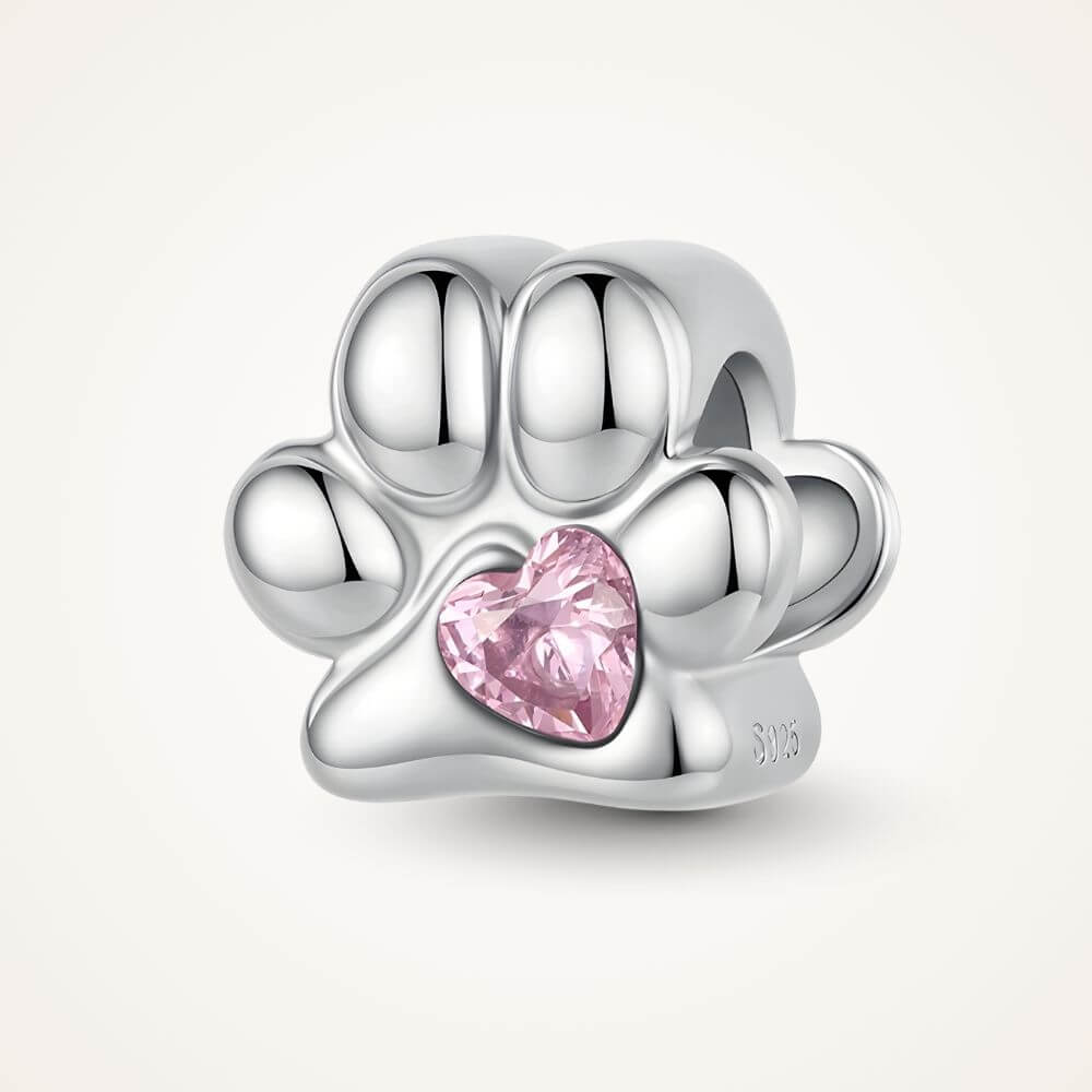 Sterling silver paw print charm with pink heart crystal center and polished pet-inspired details - ORÉYA