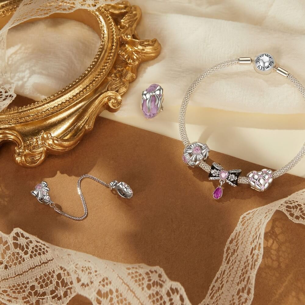 Sterling silver heart charm with pink crystals and quilted padded design.