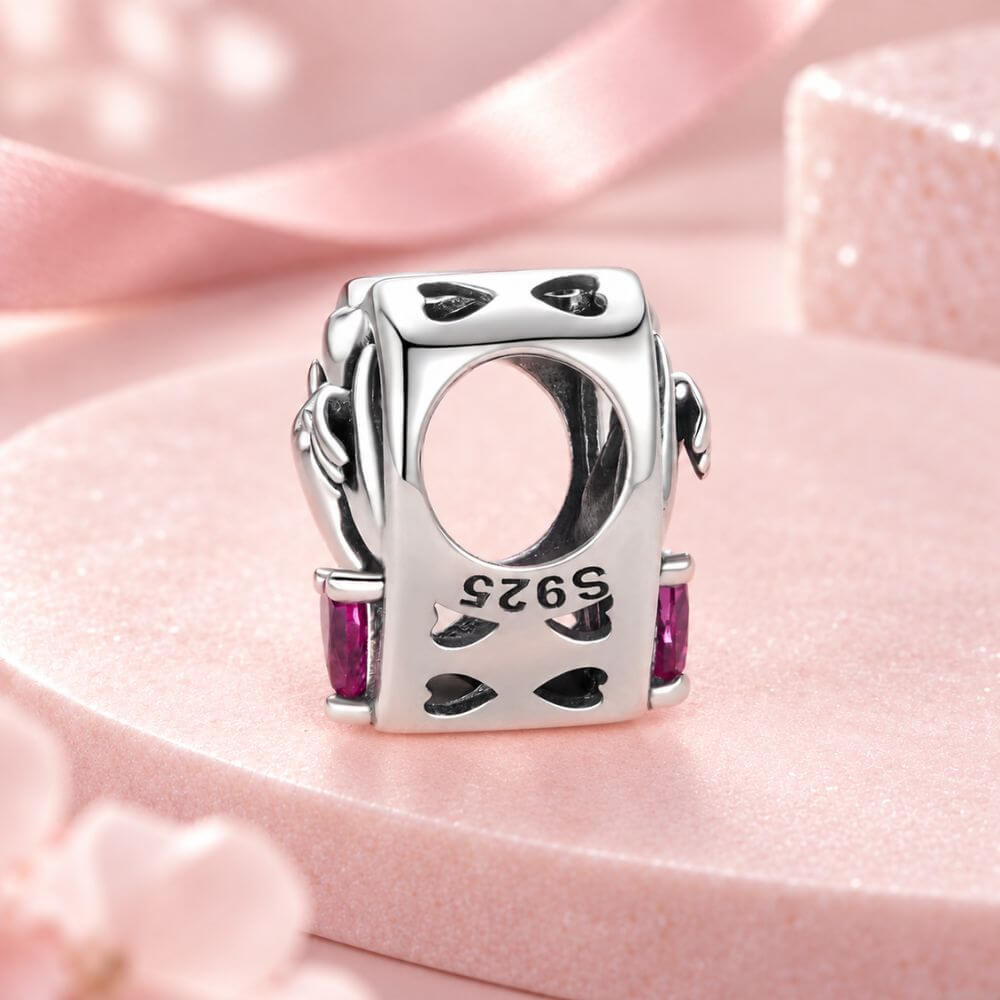 Sterling silver pinky promise charm with intertwined hands, pink heart crystal, and romantic heart frame.