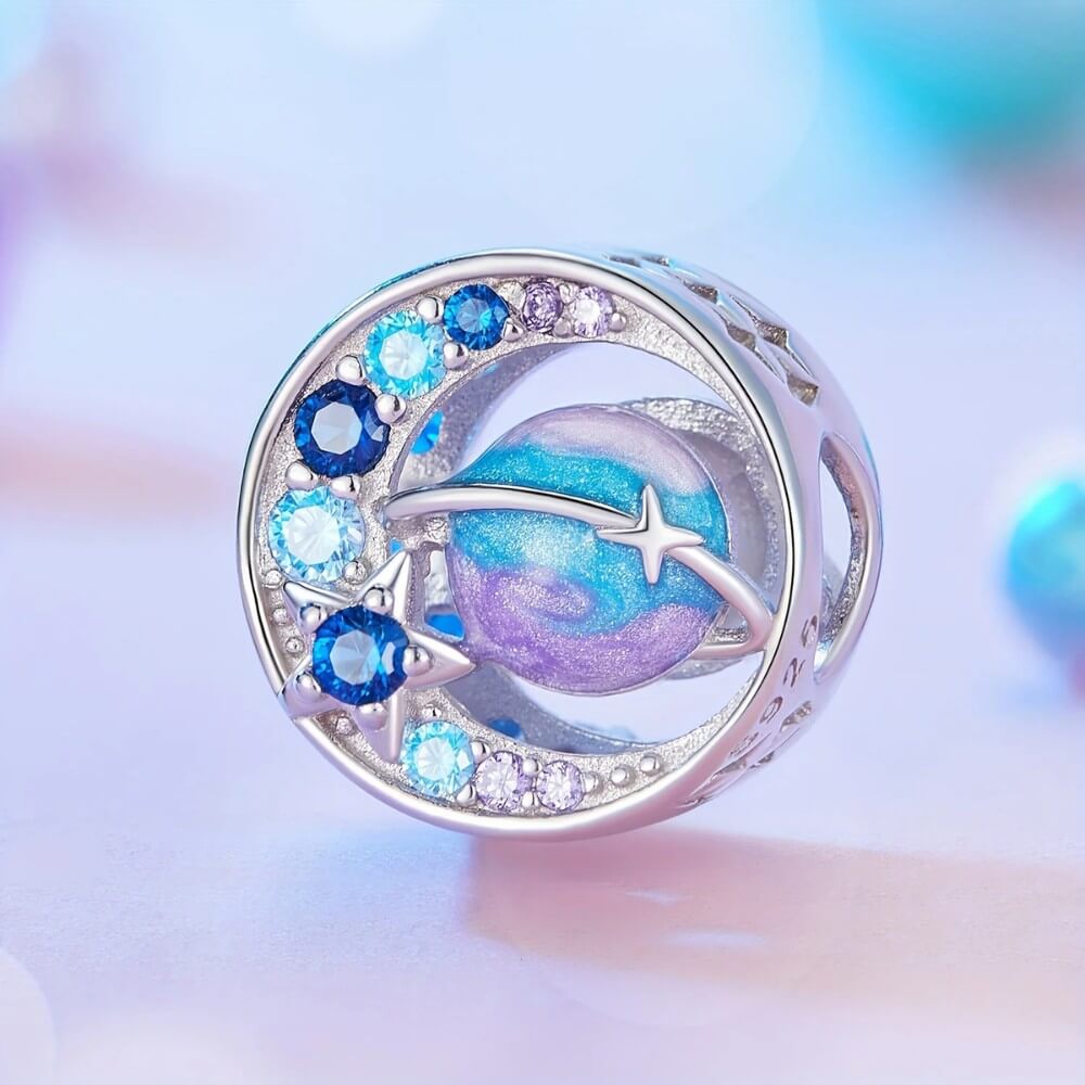Sterling silver planet charm with blue purple crystals and sparkling star details.