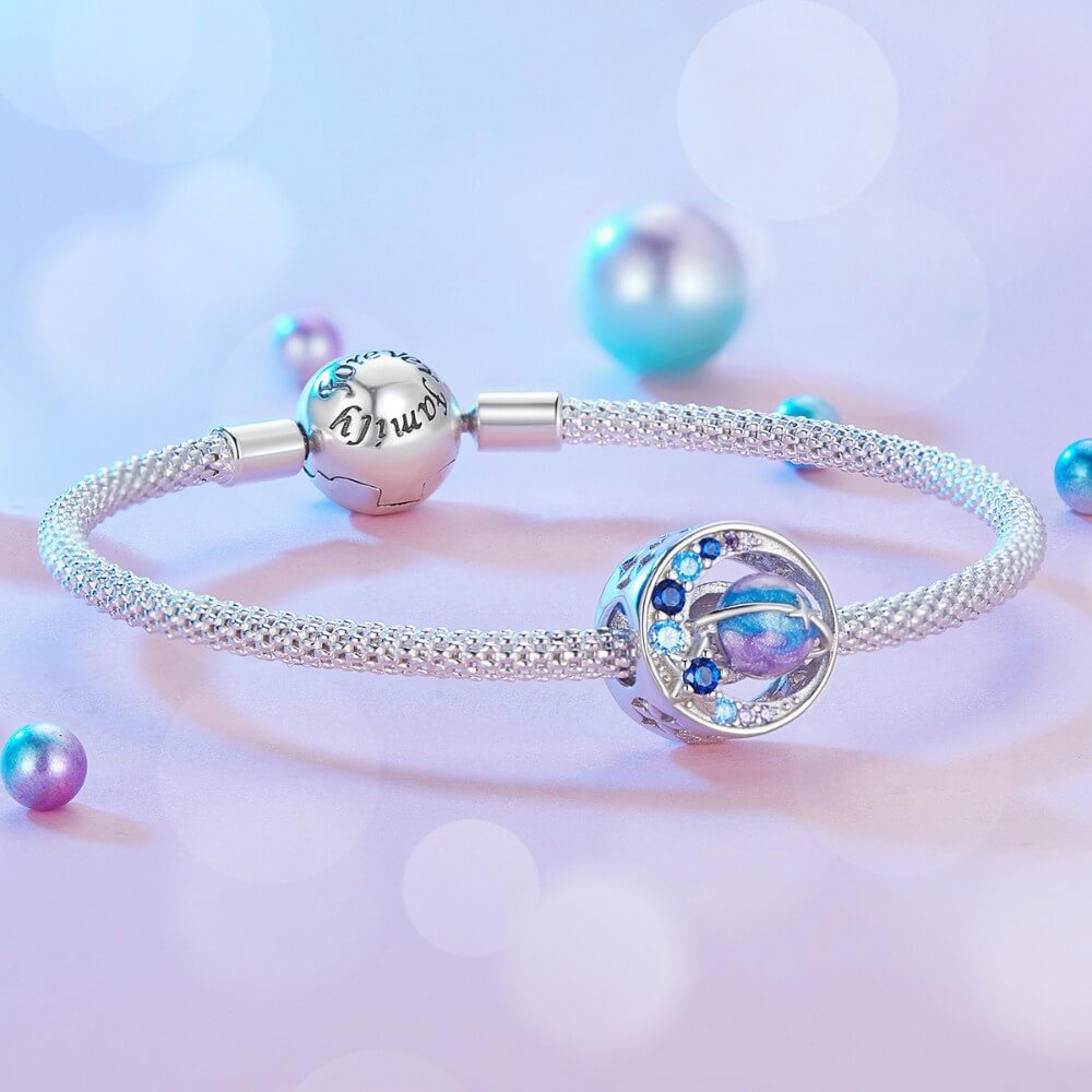 Sterling silver planet charm with blue purple crystals and sparkling star details.